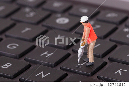 Miniature worker with drill working on keyboard Miniature worker with drill working on keyboard 12741812