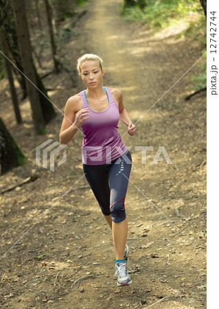 Pretty young girl runner in the forest. Pretty young girl runner in the forest. 12742744