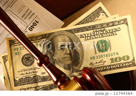 Wooden gavel, tax form and banknotes Wooden gavel, tax form and banknotes 12744564