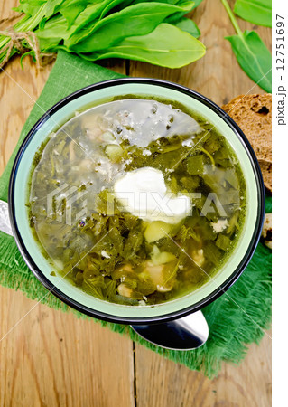 Soup green of sorrel and spinach with sour cream on board 12751697