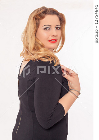 Beautiful buxom woman in a black dress Beautiful buxom woman in a black dress 12754641