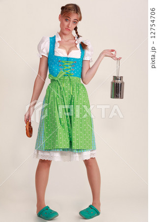 Young woman in dirndl with extremely silly face 12754706