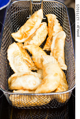 Gyoza deep fried in stove. 12755025