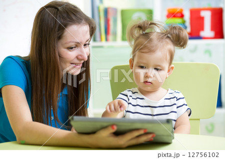 mother and her kid daughter with tablet pc 12756102
