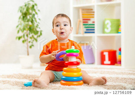 funny child playing with color toy indoor 12756109