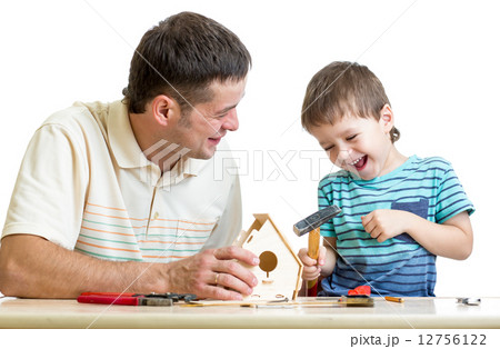 Father and son working with hammer together 12756122