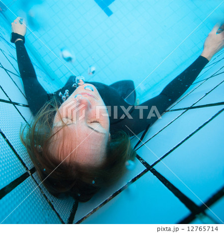 Female diver with eyes closed underwater in swimming pool 12765714