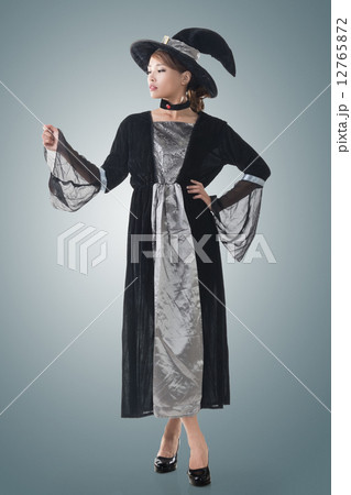 Asian witch hold something 12765872