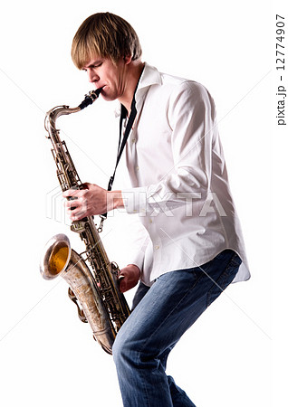 Young man with saxophone over white background Young man with saxophone over white background 12774907