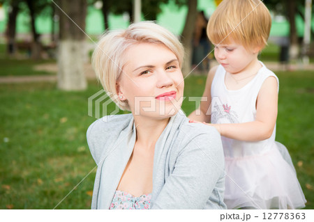 portrait of beautiful mother and kid girl outdoors in park portrait of beautiful mother and kid girl outdoors in park 12778363