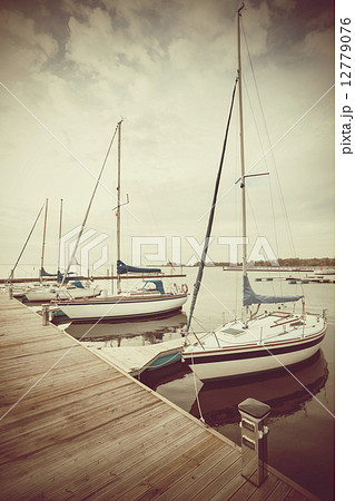 Retro filtered picture of yachts at pier. 12779076