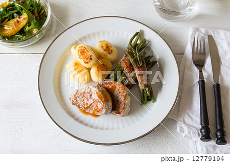 Pork medallions with potatoes and beans 12779194