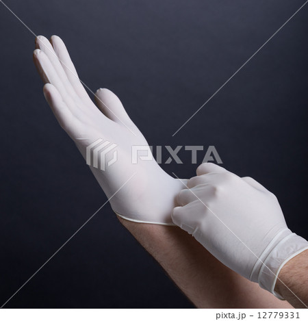 Putting on latex gloves 12779331