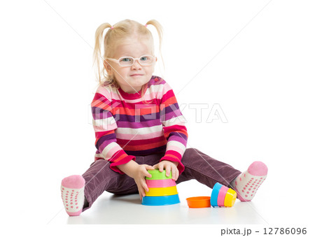 Funny child in eyeglases playing colorful pyramid toy isolated Funny child in eyeglases playing colorful pyramid toy isolated 12786096