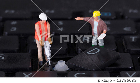 Miniature workers with drill working on keyboard Miniature workers with drill working on keyboard 12786635