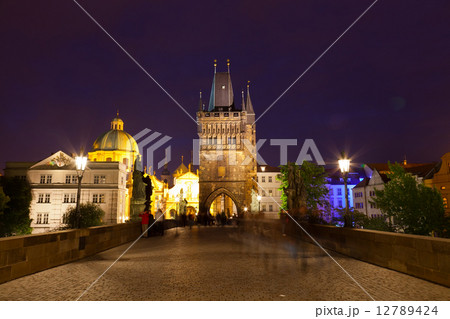 Tourists near Charles bridge in Prague at night 12789424