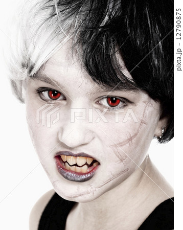Young Girl in Wig Posing as Vampire 12790875