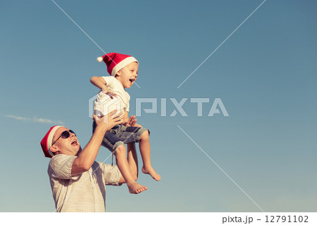 father and little son playing near a house father and little son playing near a house 12791102