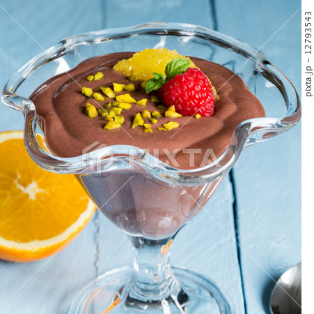 Chocolate pudding dessert with orange and pistachio 12793543