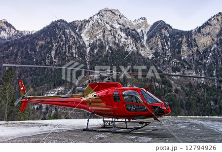Red helicopter in heliport at swiss alps Red helicopter in heliport at swiss alps 12794926