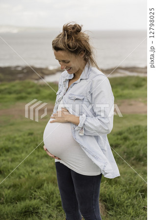 A pregnant woman on a coastal path. A pregnant woman on a coastal path. 12798025