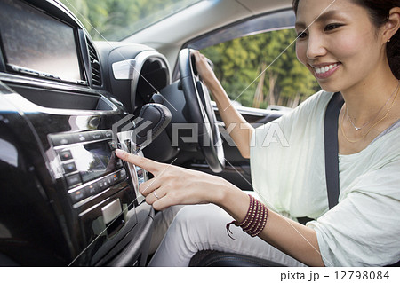 A young woman sitting in her car. 12798084