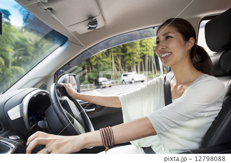 A young woman sitting in her car. 12798088
