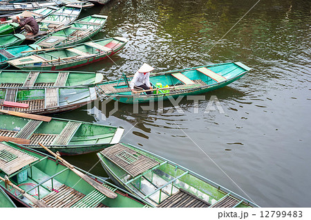 Vietnamese woman in a boat on the river. Ninh Binh. Vietnam Vietnamese woman in a boat on the river. Ninh Binh. Vietnam 12799483