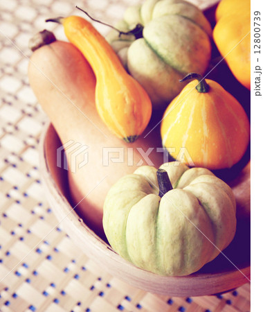Various of pumpkins on bowl with retro filter effect 12800739
