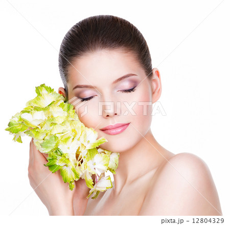 Portrait of beautiful young woman with green flower. Portrait of beautiful young woman with green flower. 12804329