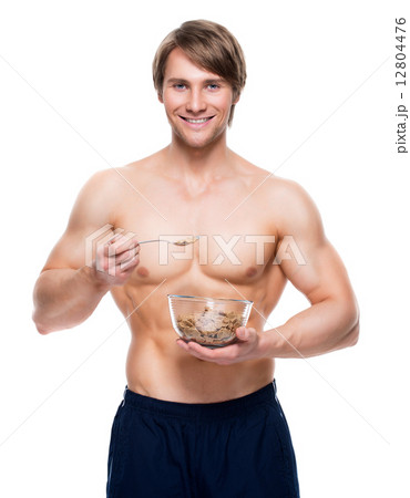 Young  muscular man eating flakes. 12804476