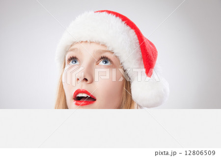Christmas woman in santa hat holding empty board 12806509