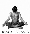 A young Indian modern man meditatin in lotus pose 12822069