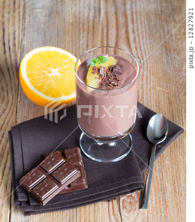 Chocolate pudding dessert with orange and grated chocolate 12827921