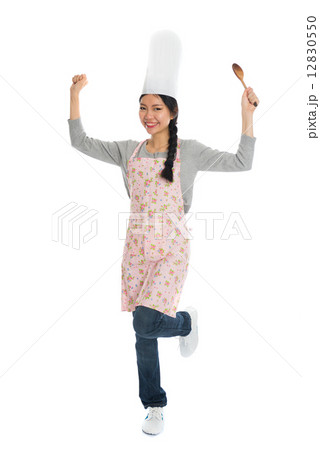 asian female chef holding a spoon asian female chef holding a spoon 12830550