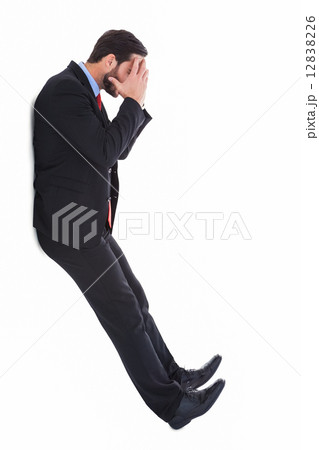 Worried businessman with head in hands 12838226