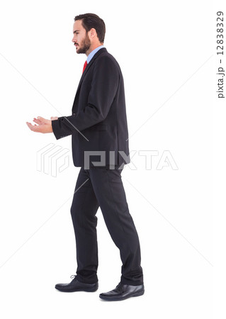 Businessman walking and presenting with hands 12838329