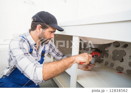 Plumber fixing under the sink Plumber fixing under the sink 12838562