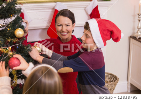 Mother son and daughter decorating the christmas tree 12838795