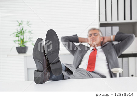 Relaxed businessman with his feet up Relaxed businessman with his feet up 12838914
