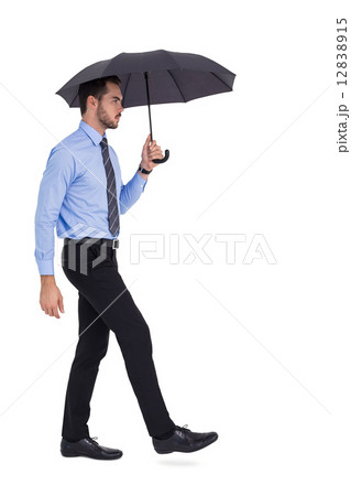 Focused businessman under umbrella stepping Focused businessman under umbrella stepping 12838915