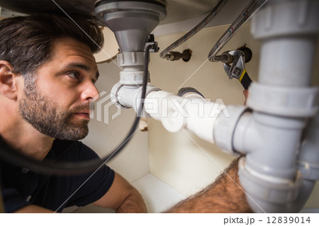 Plumber fixing under the sink Plumber fixing under the sink 12839014