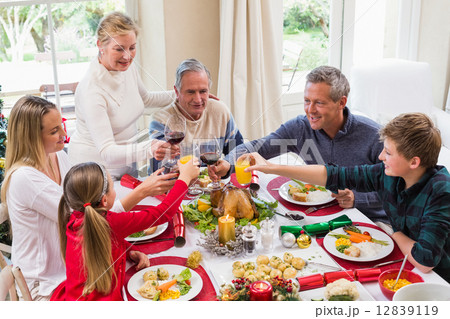 Family toasting with red wine in a christmas dinner 12839119