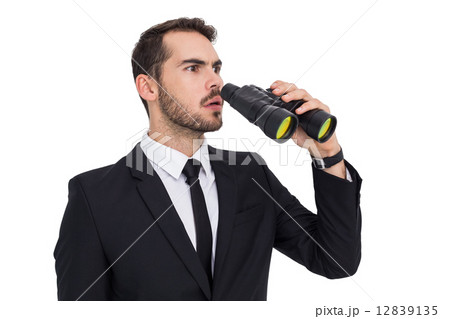 Surprised businessman standing and holding binoculars Surprised businessman standing and holding binoculars 12839135