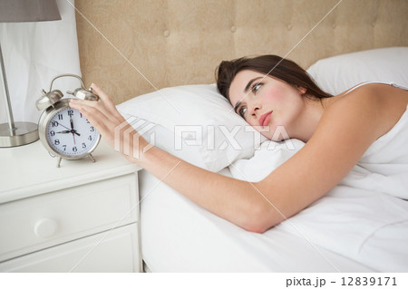 Pretty brunette turning off her alarm 12839171