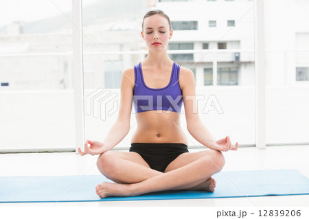 Fit brunette sitting in lotus pose 12839206