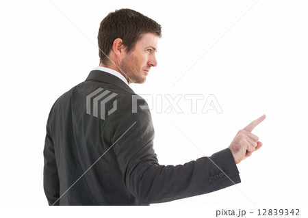 Serious businessman standing and pointing the finger 12839342