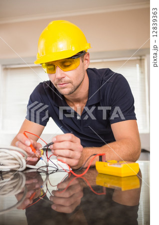 Construction worker working on cables 12839363