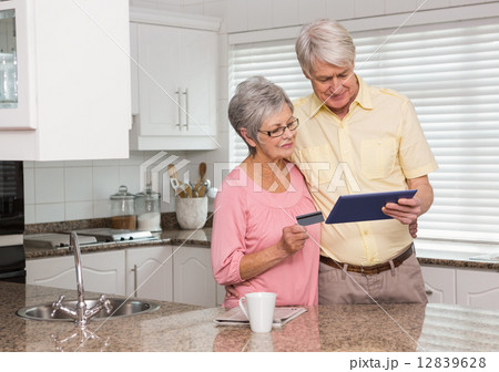 Senior couple shopping online with tablet pc Senior couple shopping online with tablet pc 12839628