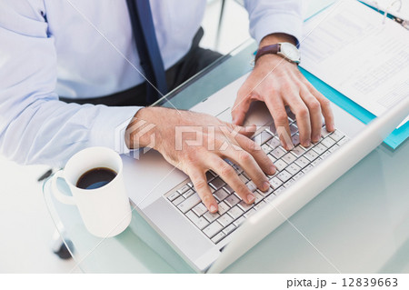 Businessman using his laptop Businessman using his laptop 12839663